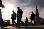 Commuters cross London Bridge in the City of London.
