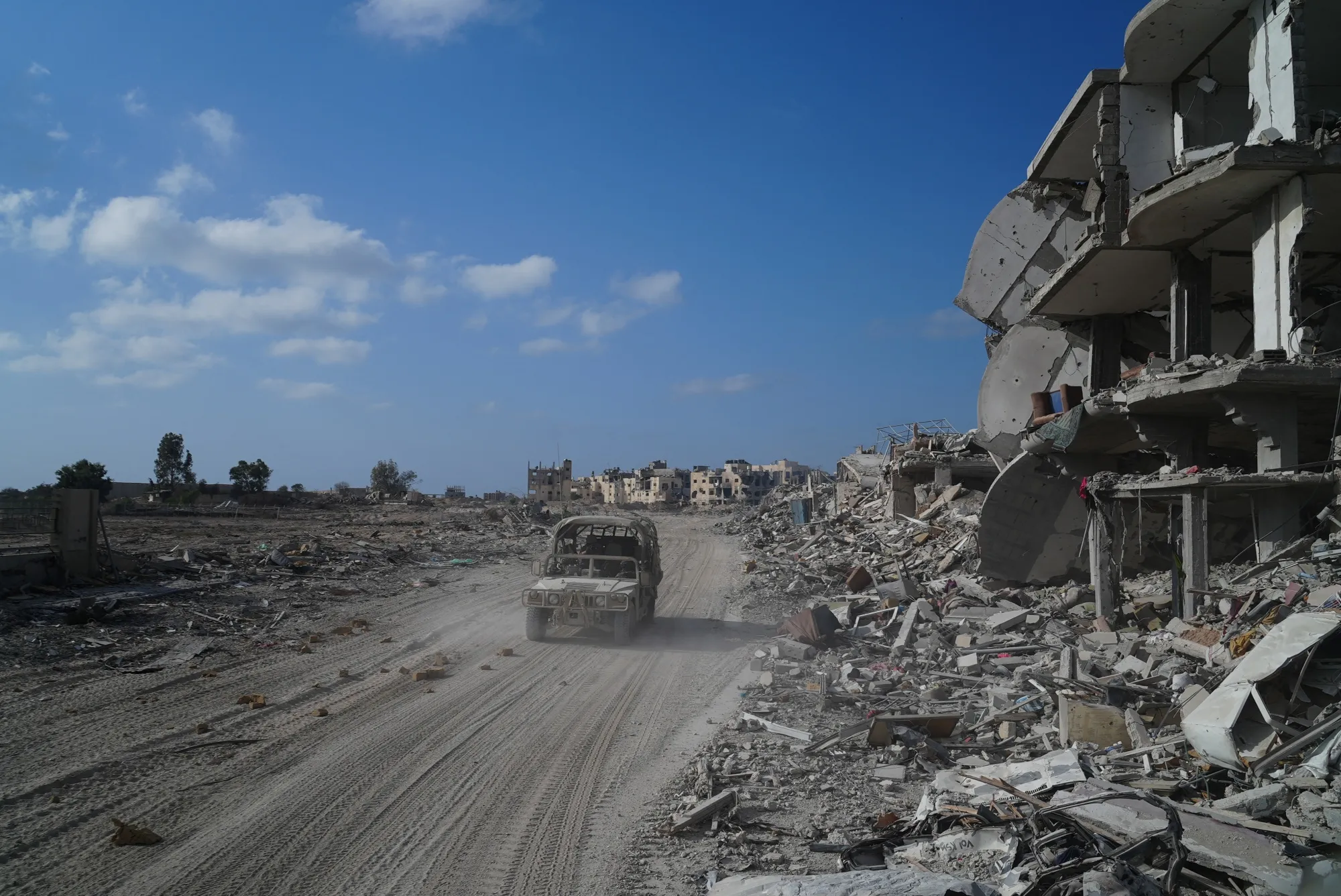 In a photo taken during a&nbsp;tour with the Israeli military,&nbsp;&nbsp;Israeli Military&nbsp;soldiers drive past destroyed buildings in Rafah&nbsp;on Sept. 13.