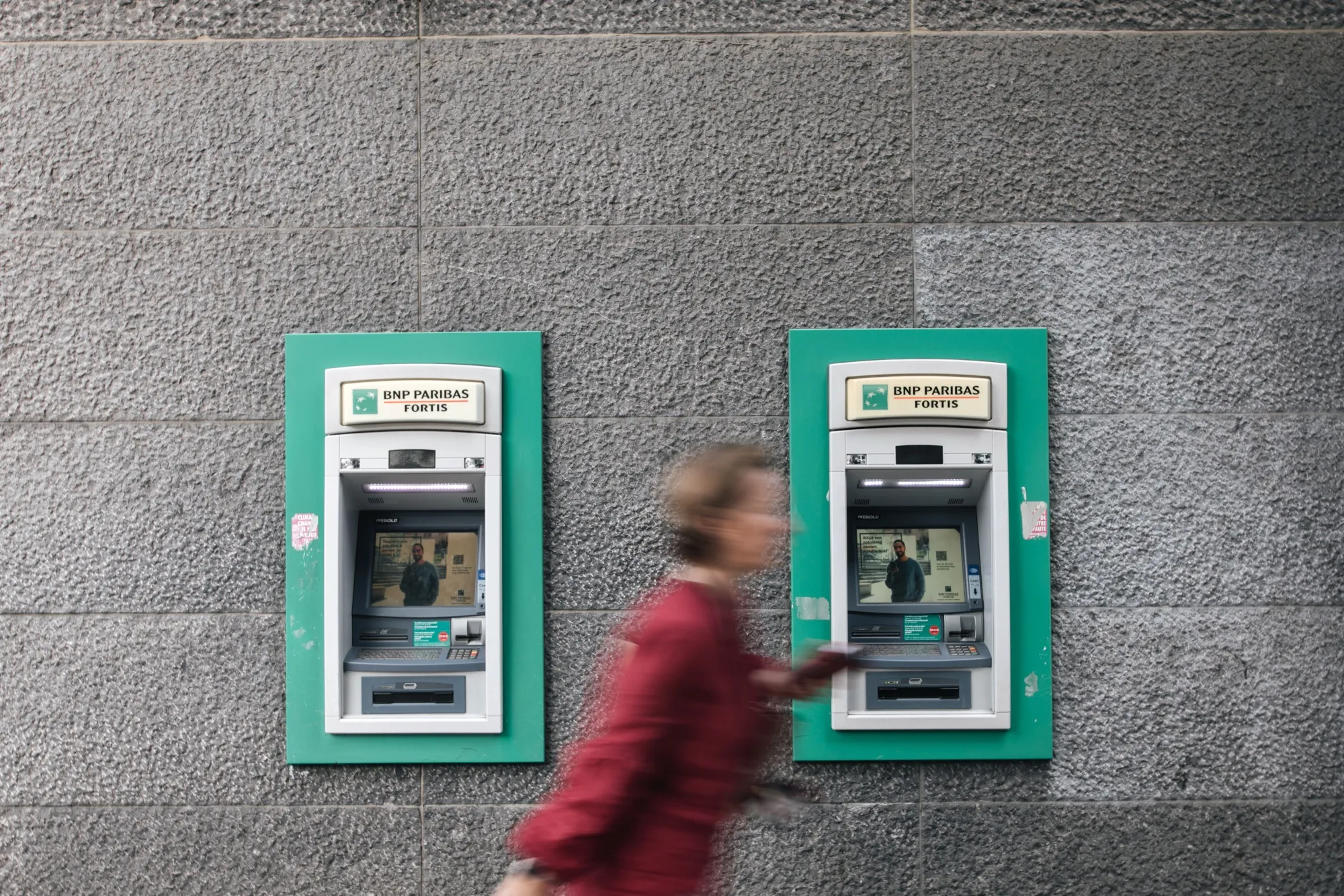 Automated teller machines outside a BNP Paribas SA bank branch in Brussels, Belgium.