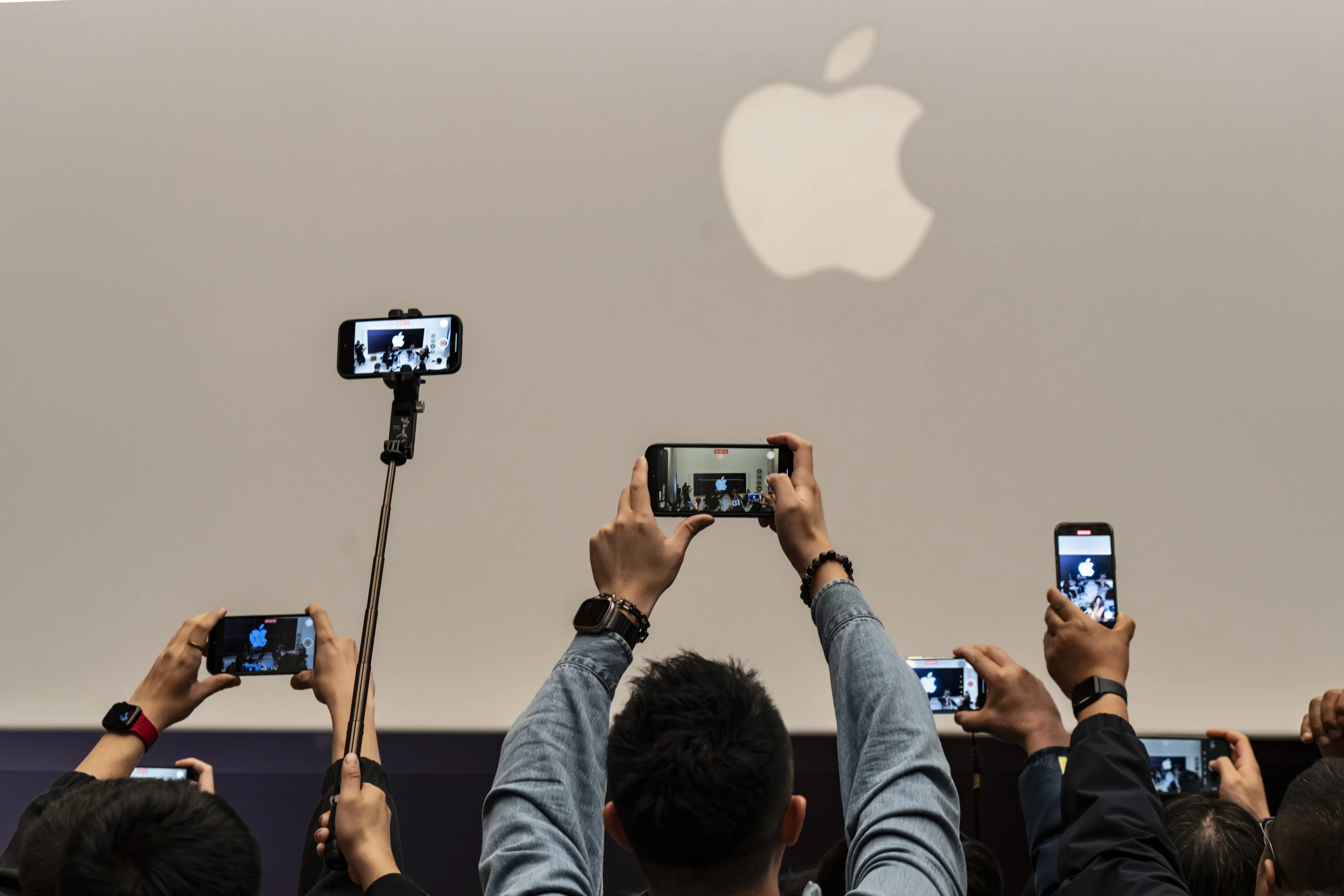 Customers take photographs during the opening of the new Apple store in Shanghai.