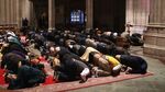 Muslims participate in a Friday prayer November 14, 2014 at the National Cathedral in Washington, DC.
