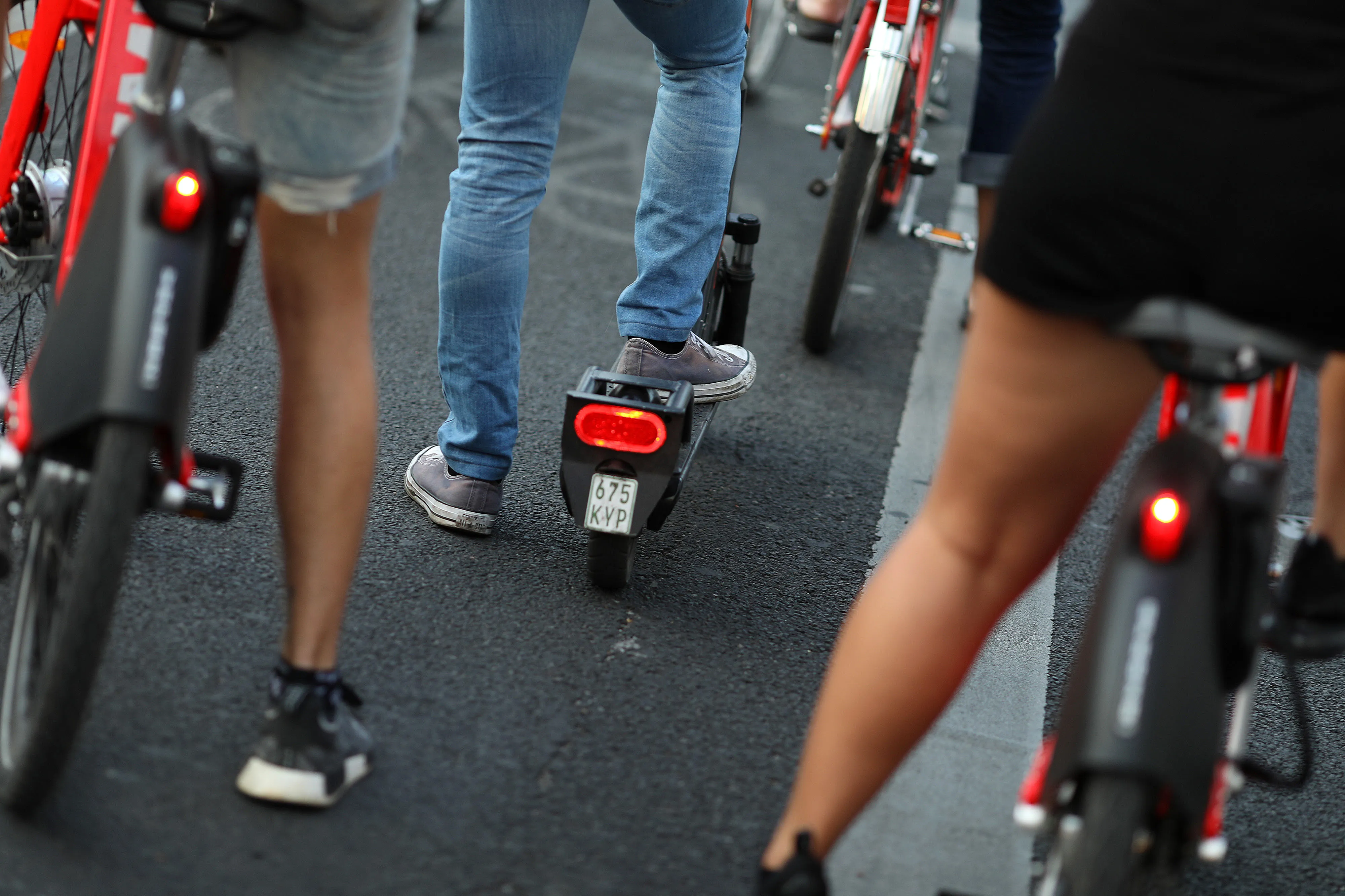Electric bicycle and scooter riders wait at cycle lane traffic light in Berlin, Germany, on Thursday, July 18, 2019.&nbsp;