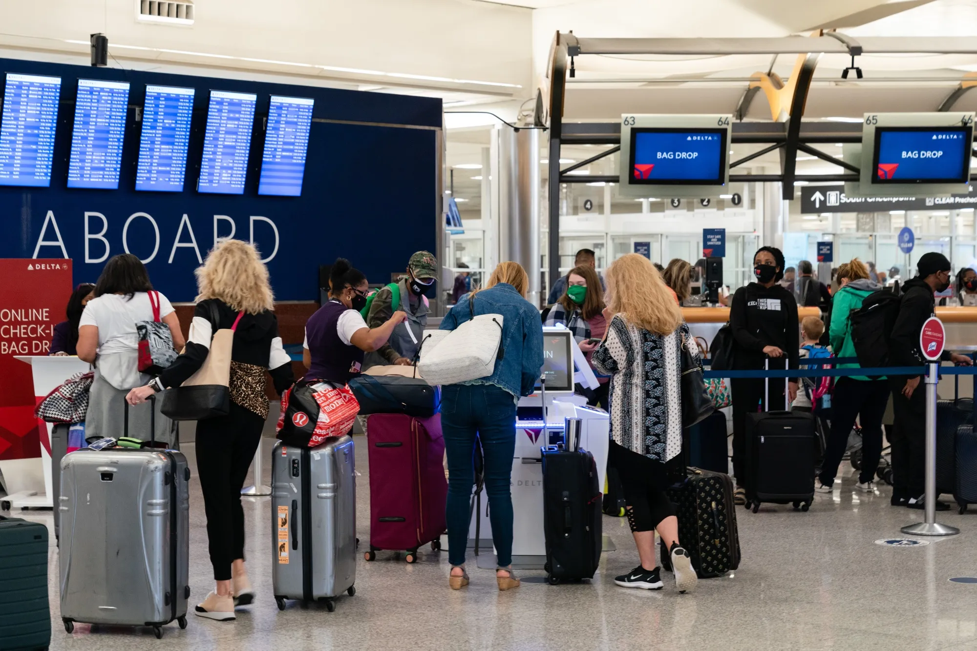 Passengers wearing protective masks check in and drop off luggage at Hartsfield-Jackson Atlanta International Airport in April.