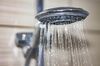 shower head with drops of water falling down