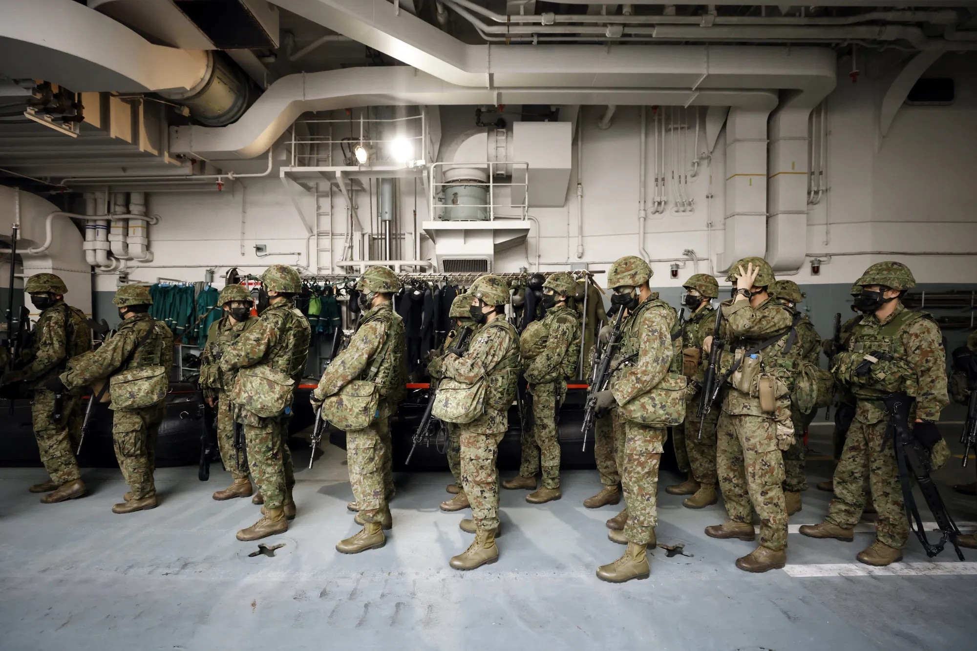 Japan Ground Self-Defense Force members&nbsp;board a landing craft during a joint exercise&nbsp;off the coast of Tanegashima island, Japan, on Nov. 25