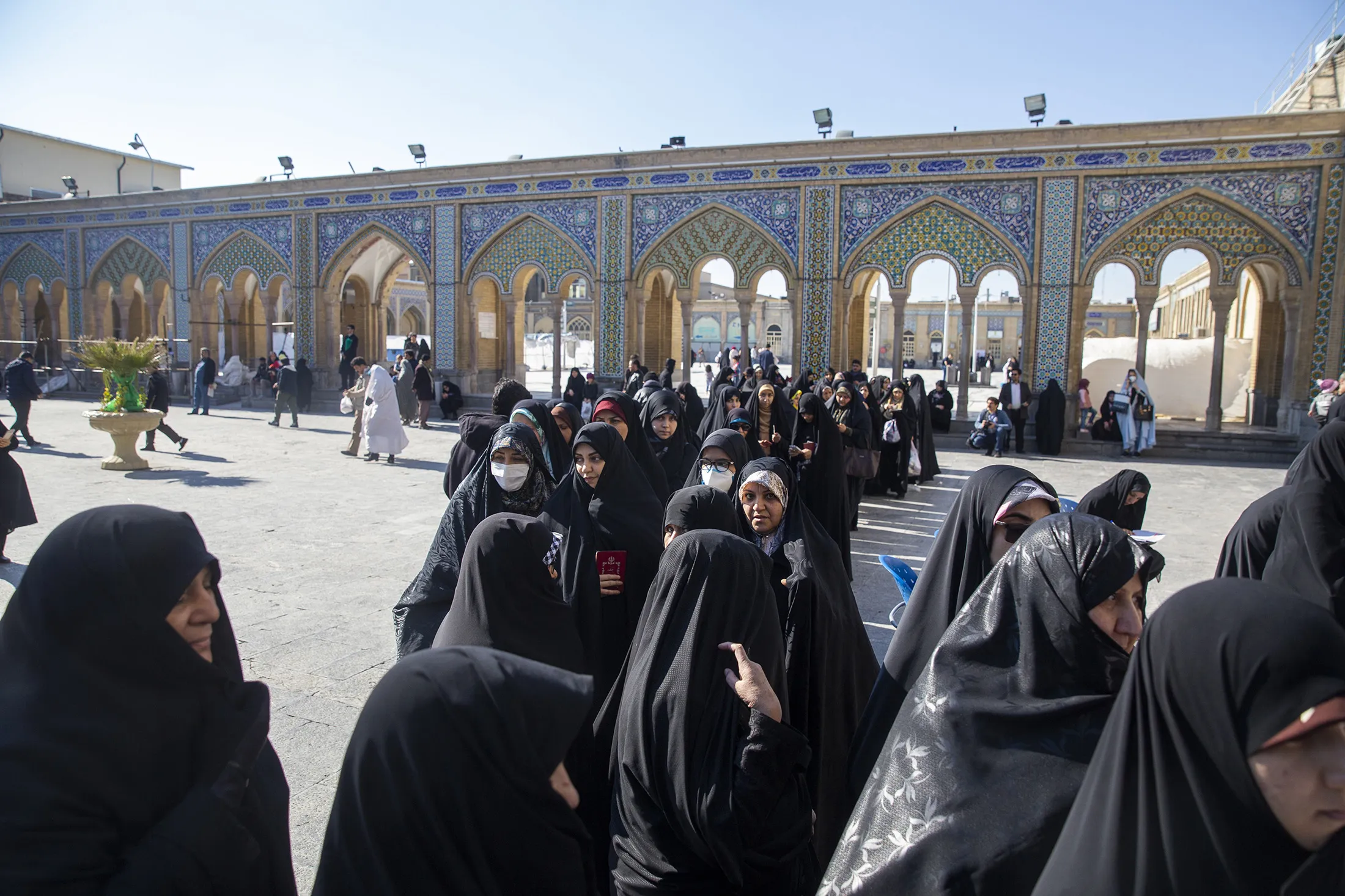 Iranians wait in line to vote in parliamentary elections on Feb. 21.