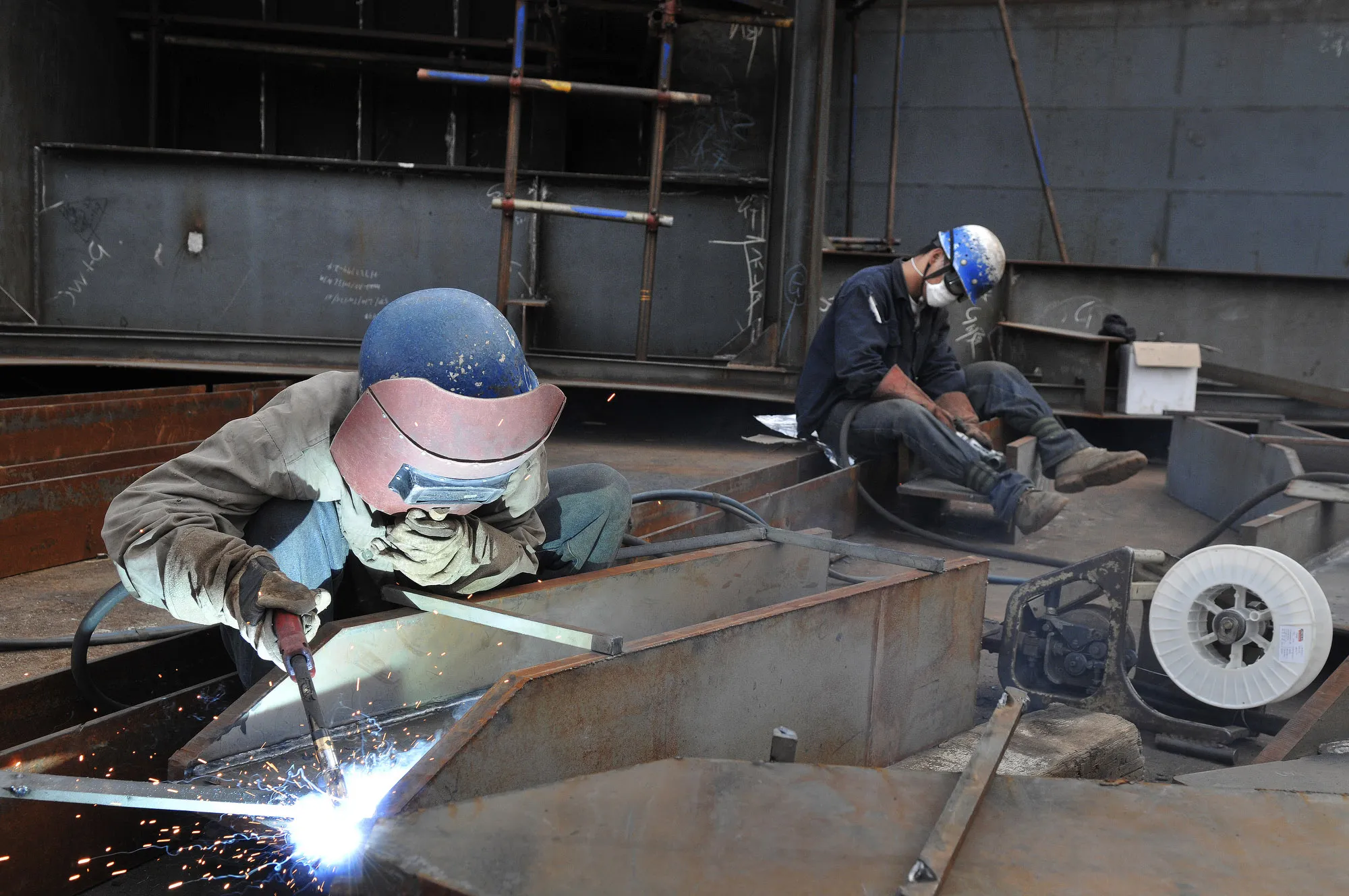 Workers weld part of a ship at a&nbsp;shipyard&nbsp;in Yantai, China.