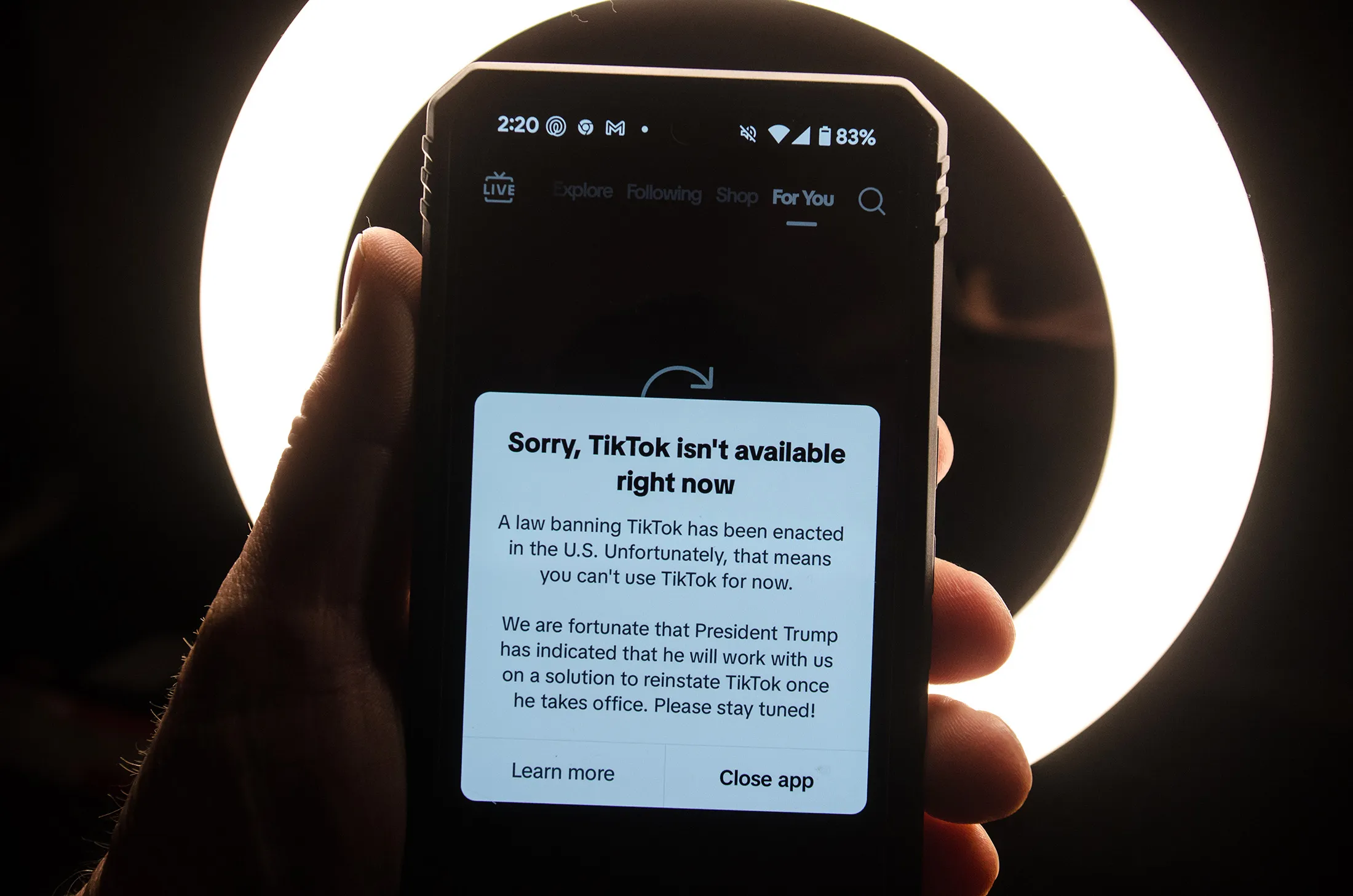 A smartphone screen displays a message indicating TikTok’s unavailability after the platform went dark on Jan. 19.