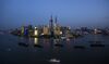 Ships pass by the skyline of the Lujiazui Financial District in Pudong in Shanghai.
