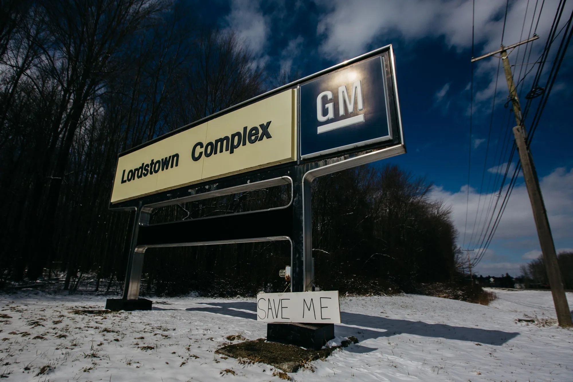 A "Save Me" sign sits displayed on GM Lordstown Complex signage near the production plant in Lordstown, Ohio on&nbsp;March 4.