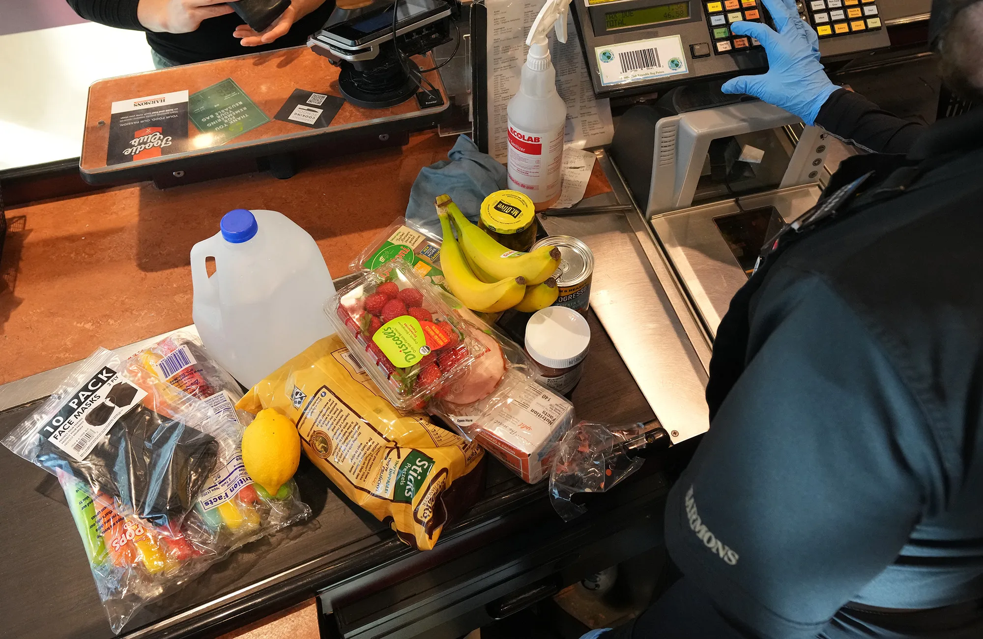 A cashier assists a customer at a checkout counter at a grocery store in Salt Lake City.