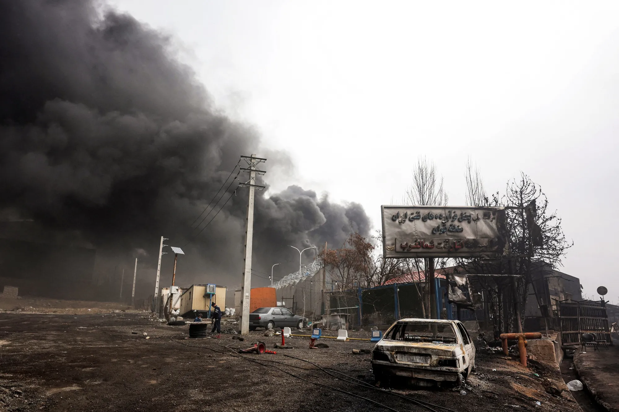 Smoke plumes rise from an ongoing fire following an airstrike on the Shahran oil refinery in northwestern Tehran on March 8.