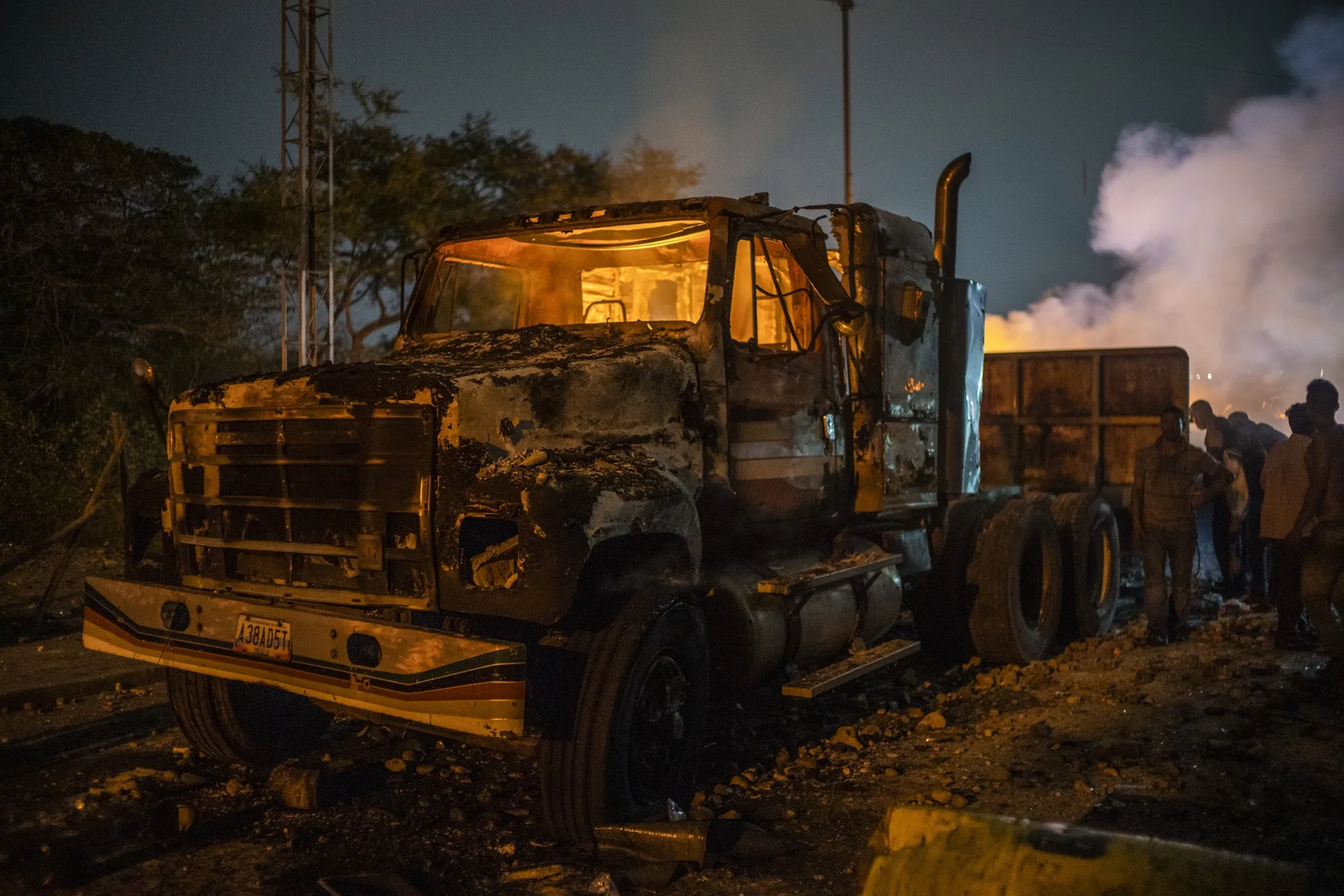 A burnt humanitarian aid truck sits following clashes on Feb. 23.