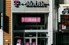 T-Mobile US Inc. signage is displayed on the exterior of a store location in New York, U.S.