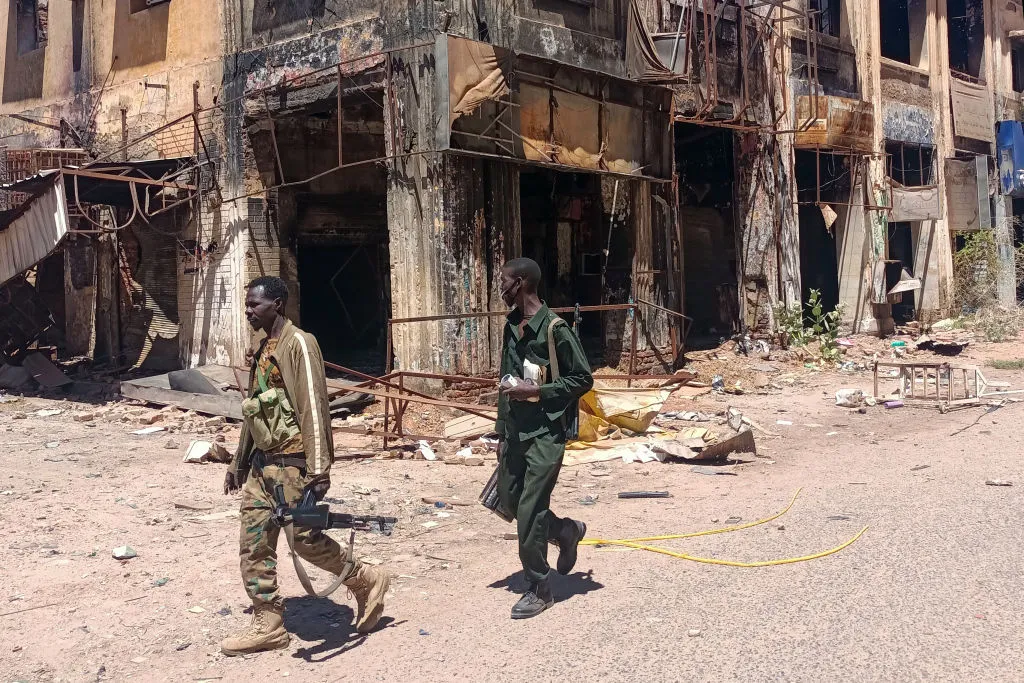 Fighters loyal to the army patrol a market area in Khartoum last month.&nbsp;