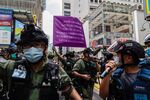Riot police raise a purple flag warning demonstrators they may be in violation of the national security law&nbsp;in Hong Kong, on Oct. 1.