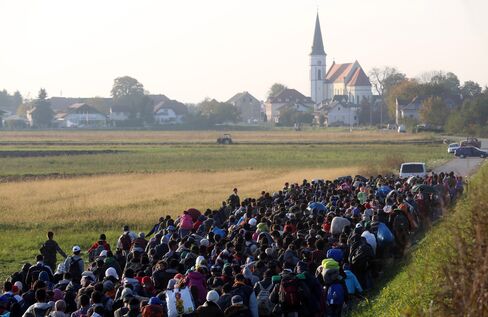Migrants are escorted near Rigonce