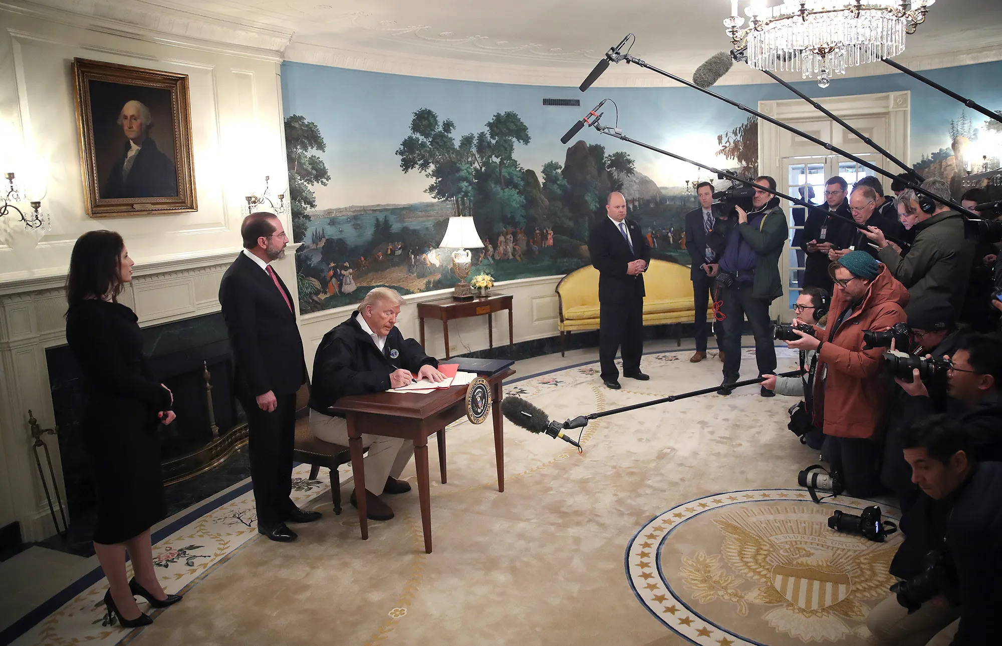 Donald Trump signs a coronavirus funding bill at the White House on March 6.