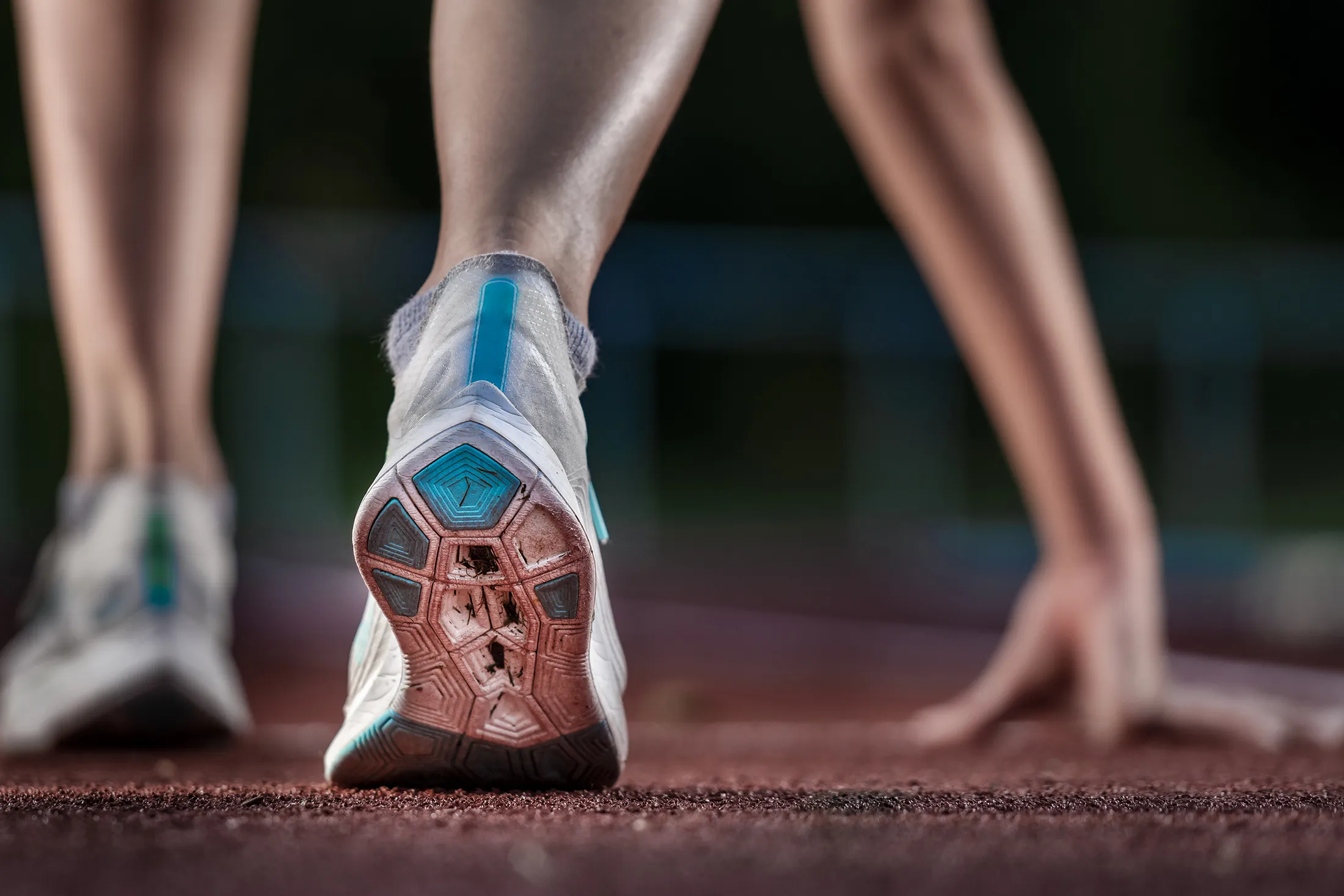 Legs of athlete running on track RF