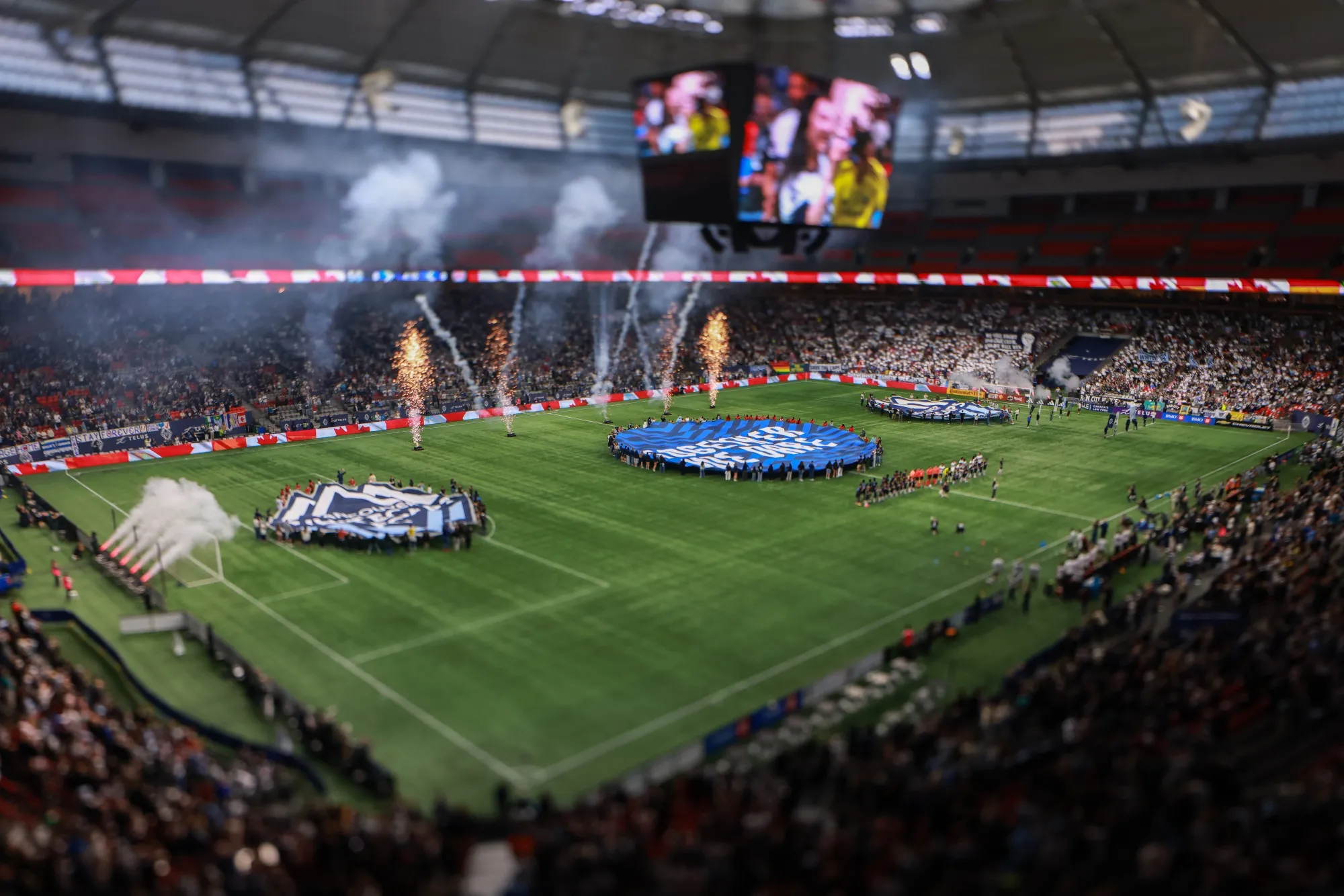 Players stand at midfield for the national anthems prior to the MLS match between Vancouver Whitecaps FC and Colorado Rapids at BC Place in Vancouver.