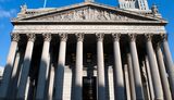New York State Supreme Court building in Lower Manhattan showing the words 'The True Administration of Justice' on its facade in Manhattan.