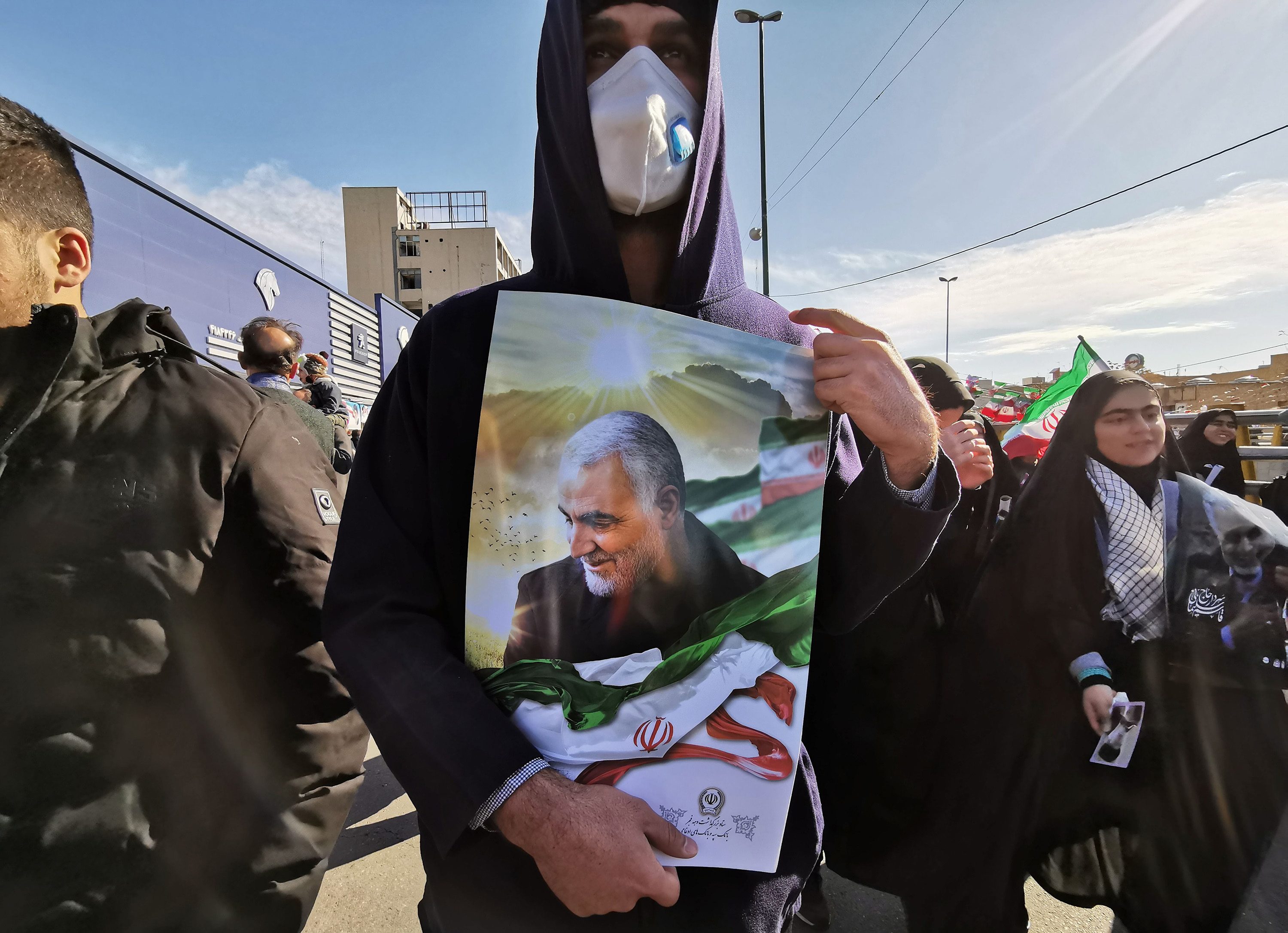 A man carries a portrait of General Qasem Soleimani during commemorations marking 41 years since the Islamic Revolution, in Tehran on Feb. 11.