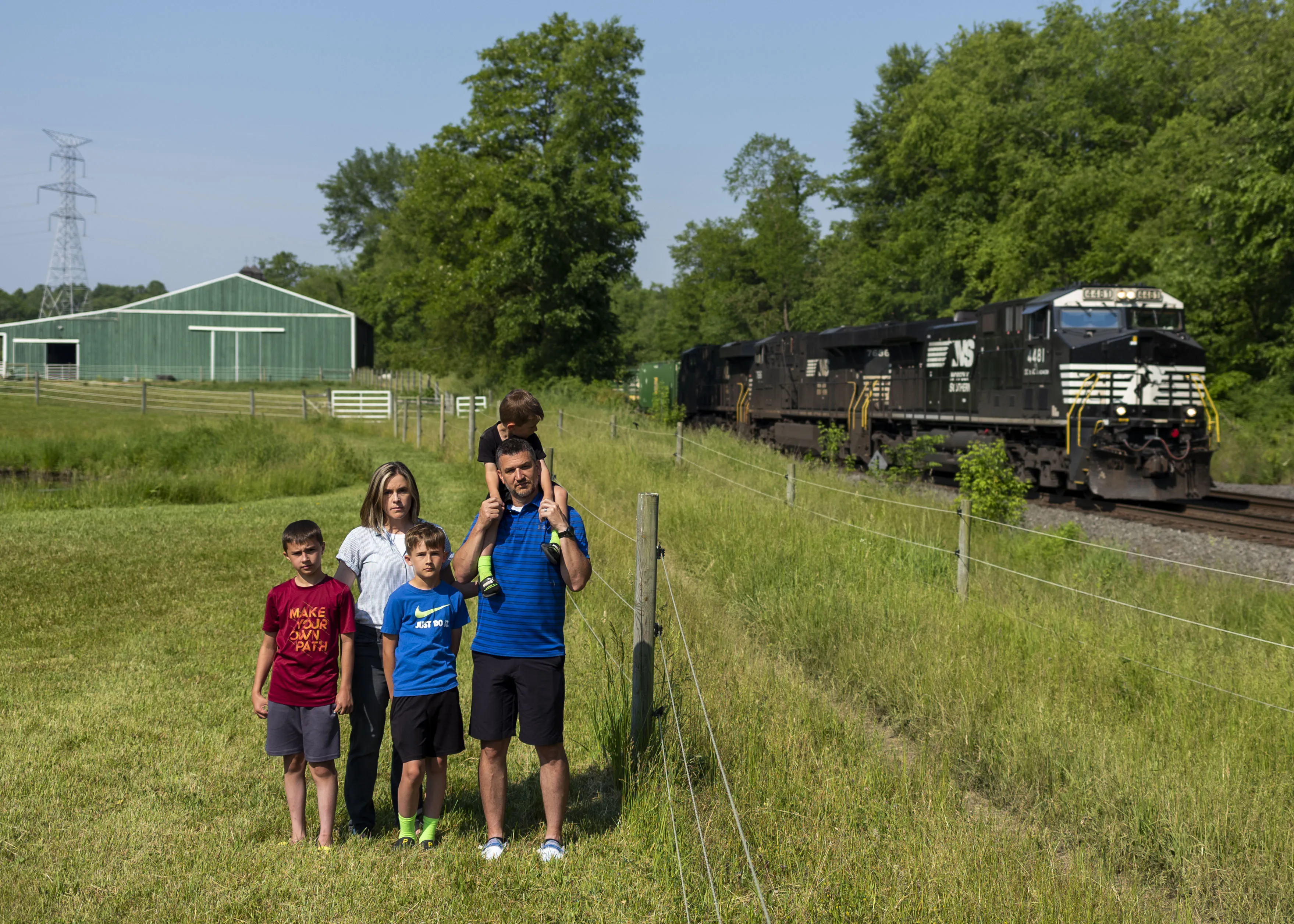 Jessica Conard, her husband Chad Conard, and their children, Noah, Jagger, and Rhys, outside their home in East Palestine. The Conards are skeptical that it is safe in East Palestine following a toxic train derailment.&nbsp;