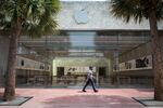 A pedestrian wearing a protective mask passes in front of an Apple Inc. store temporarily closed in Miami Beach, Florida, on&nbsp;July 17.&nbsp;
