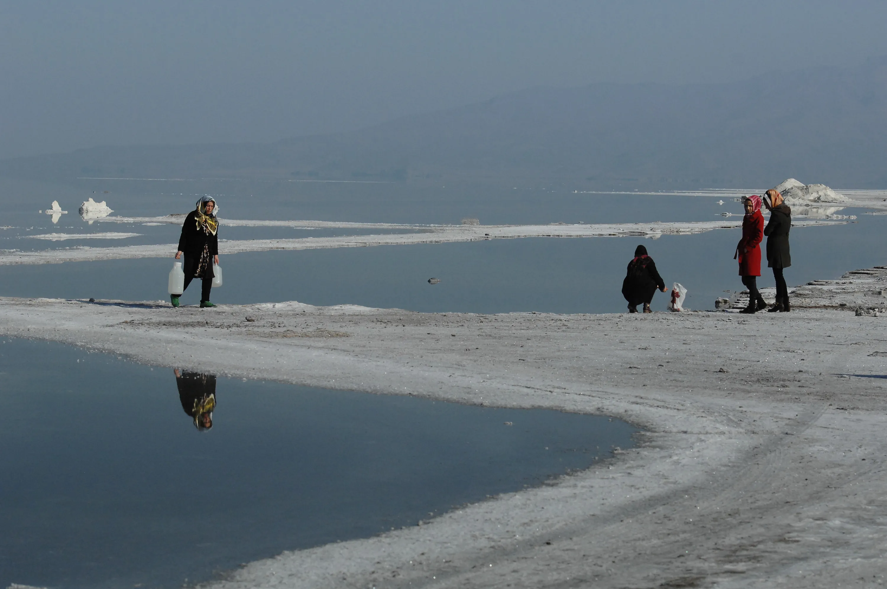 Iranians collect water from the salt-encrusted lakebed of Iran’s shrinking Lake Urmieh in 2015.
