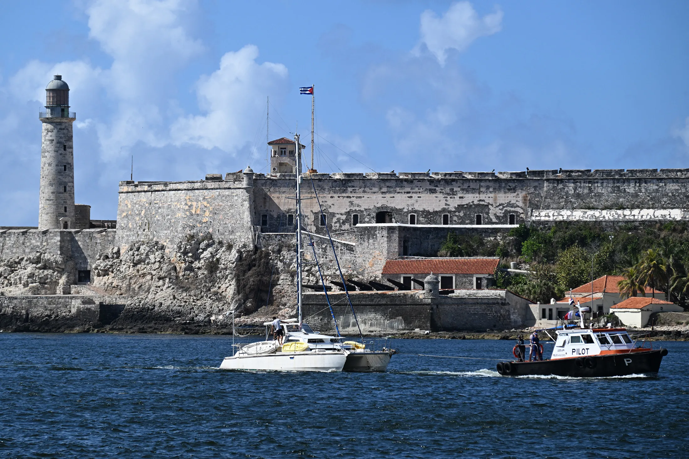 One of the two sailboats carrying humanitarian aid that had previously gone missing is tugged into the port of Havana on March 28.