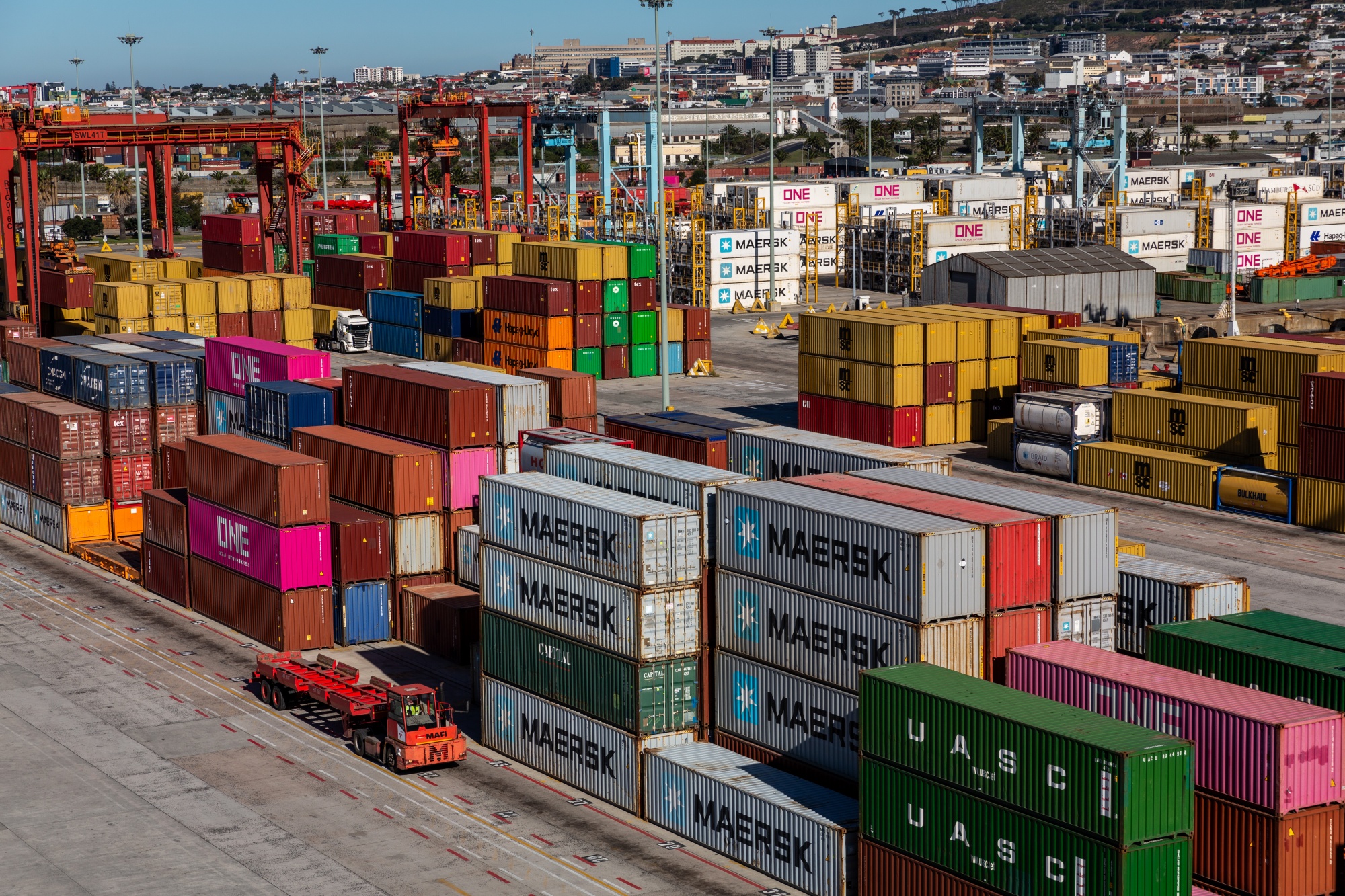 Containers stacked on a dock at the Port of Cape Town, operated by Transnet National Ports Authority, in Cape Town, South Africa, on Monday, May 13, 2024. The chaos that's enveloped Transnet — beset by corruption, theft and dilapidated equipment — is the biggest threat to the continued export of citrus fruits, a rare economic success story in South Africa's ailing economy. Photographer: Photographer: Dwayne Senior/Bloomberg