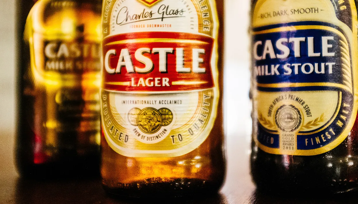 Bottles of Castle lager, Castle Milk Stout and Castle Milk Stout Chocolate beers sit in the sample room in this arranged photograph at SABMiller Plc's Newlands brewery in Cape Town, South Africa, on Wednesday, Aug. 10, 2016. Anheuser-Busch InBev NV's takeover of SABMiller Plc moved closer to completion as China’s Ministry of Commerce approved the $103 billion deal and the target's shareholders began lining up in favor of the transaction after the Budweiser maker raised its bid.
