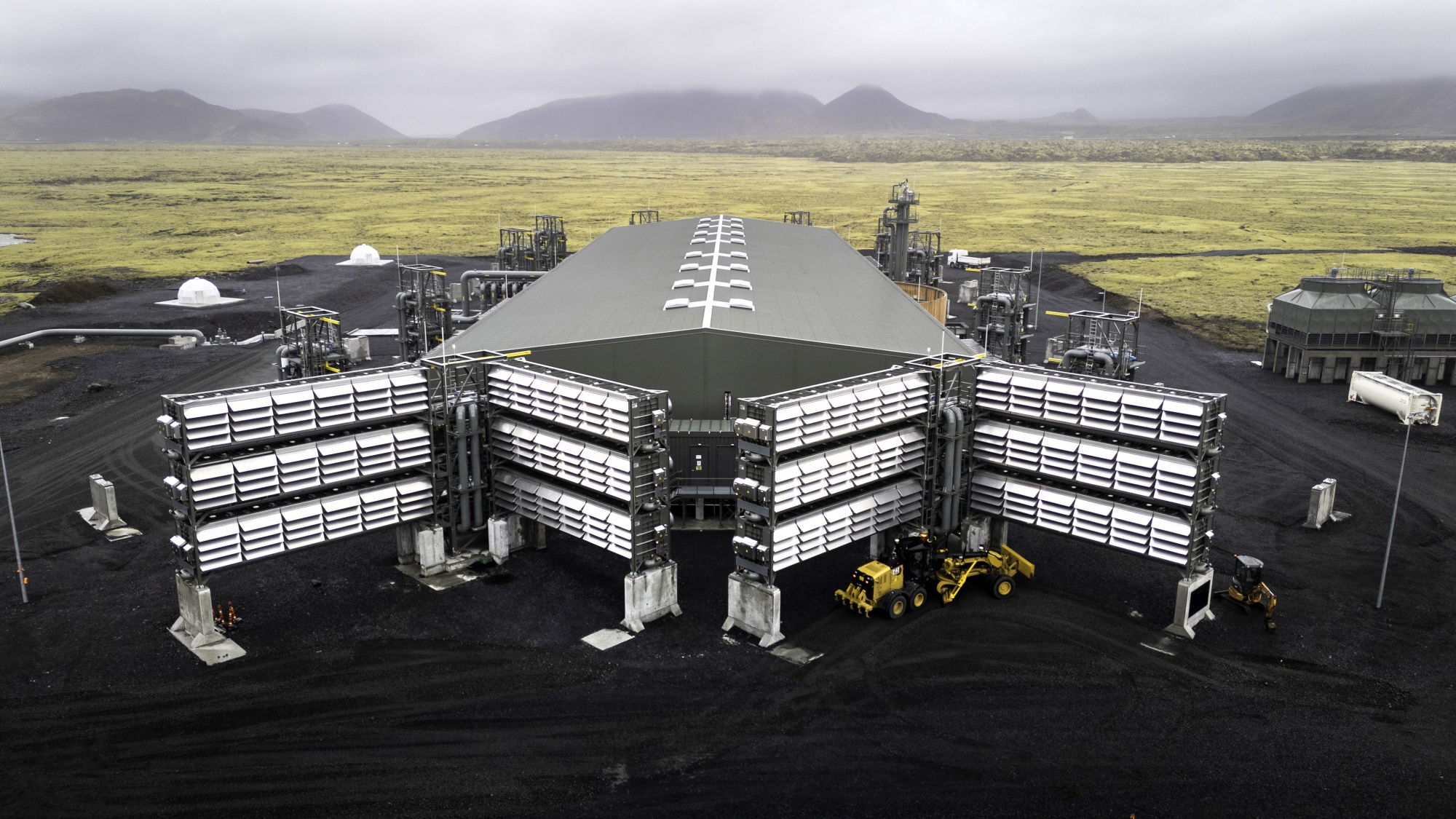 In this aerial view, the Mammoth carbon removal plant, considered the largest direct-air capture plant in the world is seen on May 24, 2024 in Reykjavik, Iceland. The Swiss start-up Climeworks and Icelandic partner Carbfix collaborated on the Mammoth project, utilizing Climeworks' Direct Air Capture (DAC) technology to extract CO2 directly from the air using fans and special filters. Powered by clean geothermal energy, the CO2 is then pumped deep into Iceland's bedrock, locking it away permanently. Mammoth's annual capture of 36,000 tons of CO2 is seen as a significant step in fighting climate change. (Photo by John Moore/Getty Images)