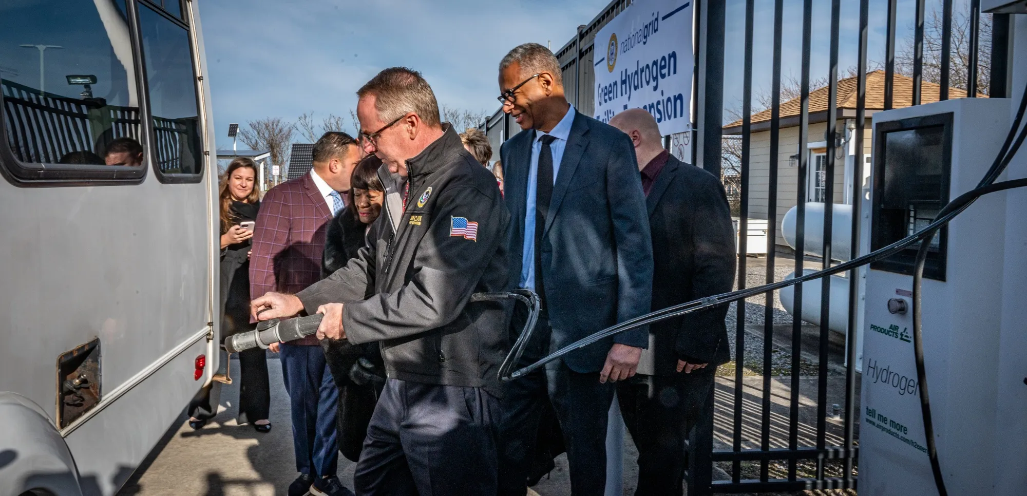 Town of Hempstead Supervisor Don Clavin and National Grid New York President Rudolph Wynter (behind Clavin) refuel a hydrogen fuel vehicle&nbsp;at a new hydrogen fueling facility in Lido Beach, New York, on Dec.&nbsp;15, 2021. The town produces its own emission-free “green” hydrogen.&nbsp;