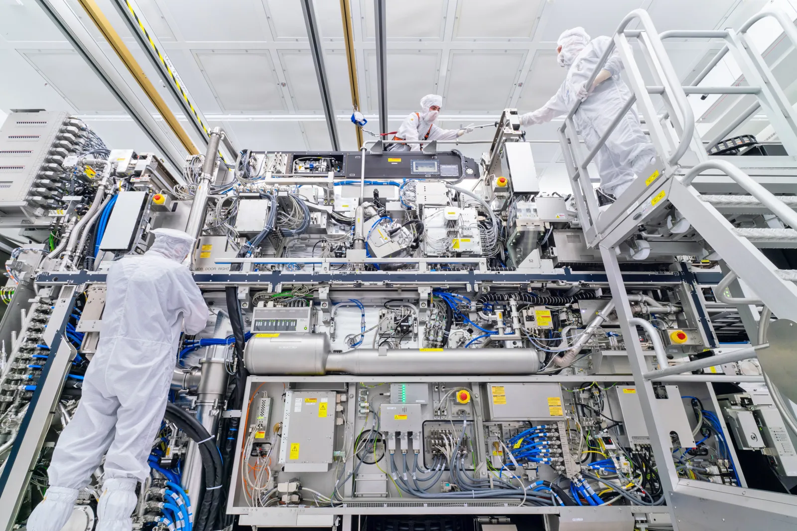 ASML technicians assemble an extreme ultraviolet lithography machine which will be used to make advanced microchips.