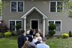 Potential home buyers visit a house in Carle Place, New York