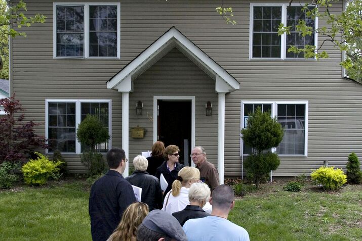 Potential home buyers visit a house in Carle Place, New York