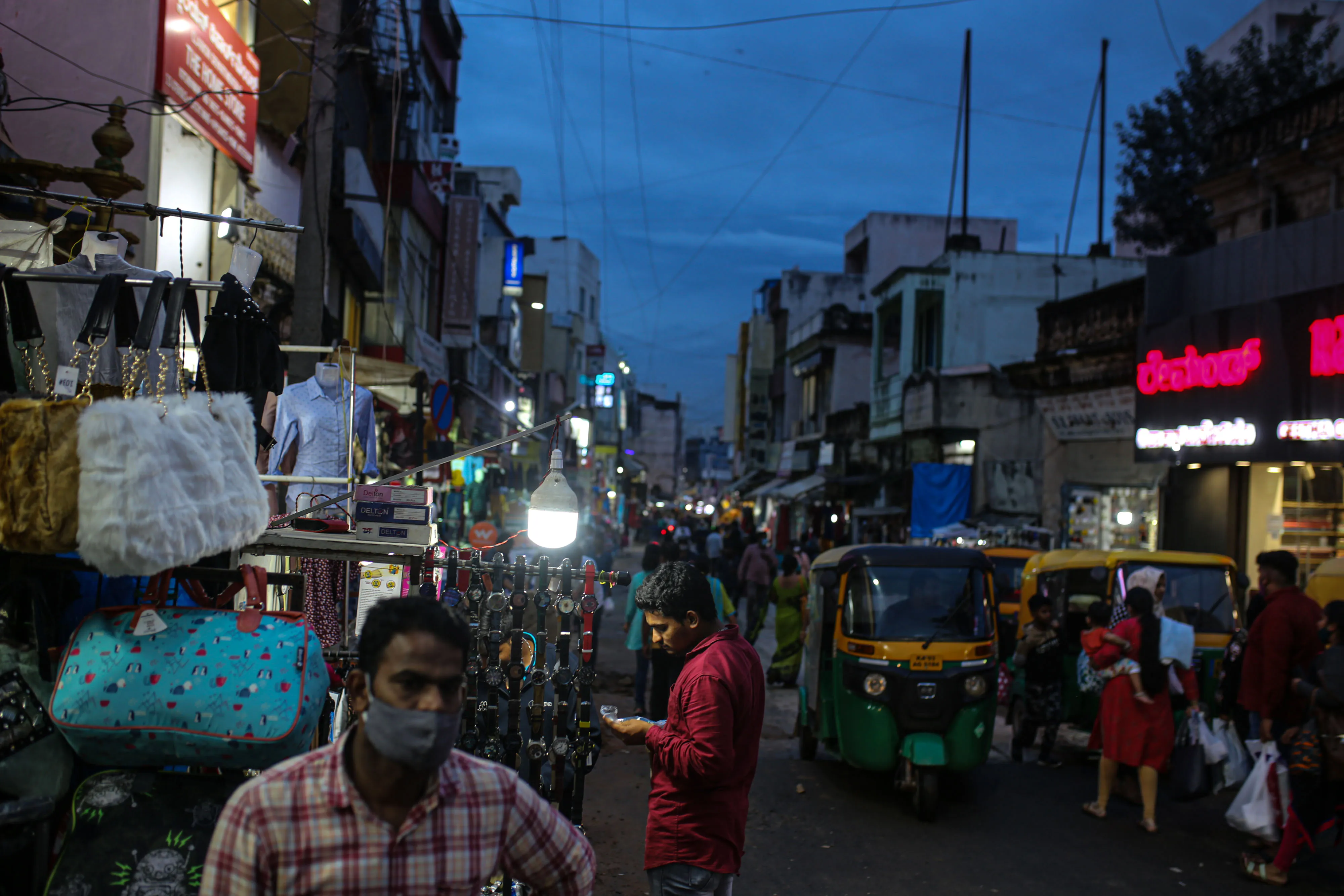 A shopper browses watches under a lamp on Brigade Road in Bengaluru, India.