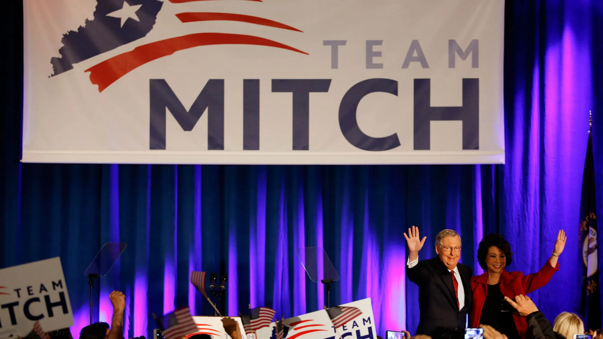 Senate Minority Leader Mitch McConnell, a Republican from Kentucky, second from right, waves to supporters alongside his wife Elaine Chao at a Republican Party of Kentucky election night party in Louisville, Kentucky, U.S., on Tuesday, Nov. 4, 2014.
