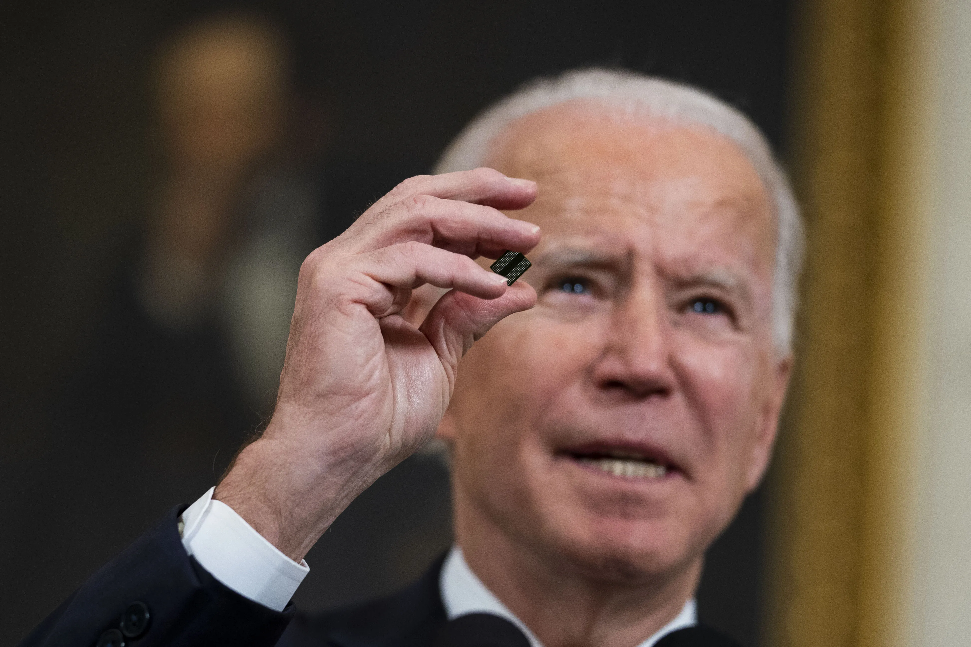 President Joe Biden holds a semiconductor before signing an executive order on Feb. 24.&nbsp;The battle over microchips –&nbsp;and the focus they’re being given in the early days of the Biden administration -- is being forced upon the new White House by necessity.
