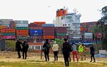 Members of the media watch as&nbsp;a container ship navigates&nbsp;Egypt's Suez Canal on March 30.