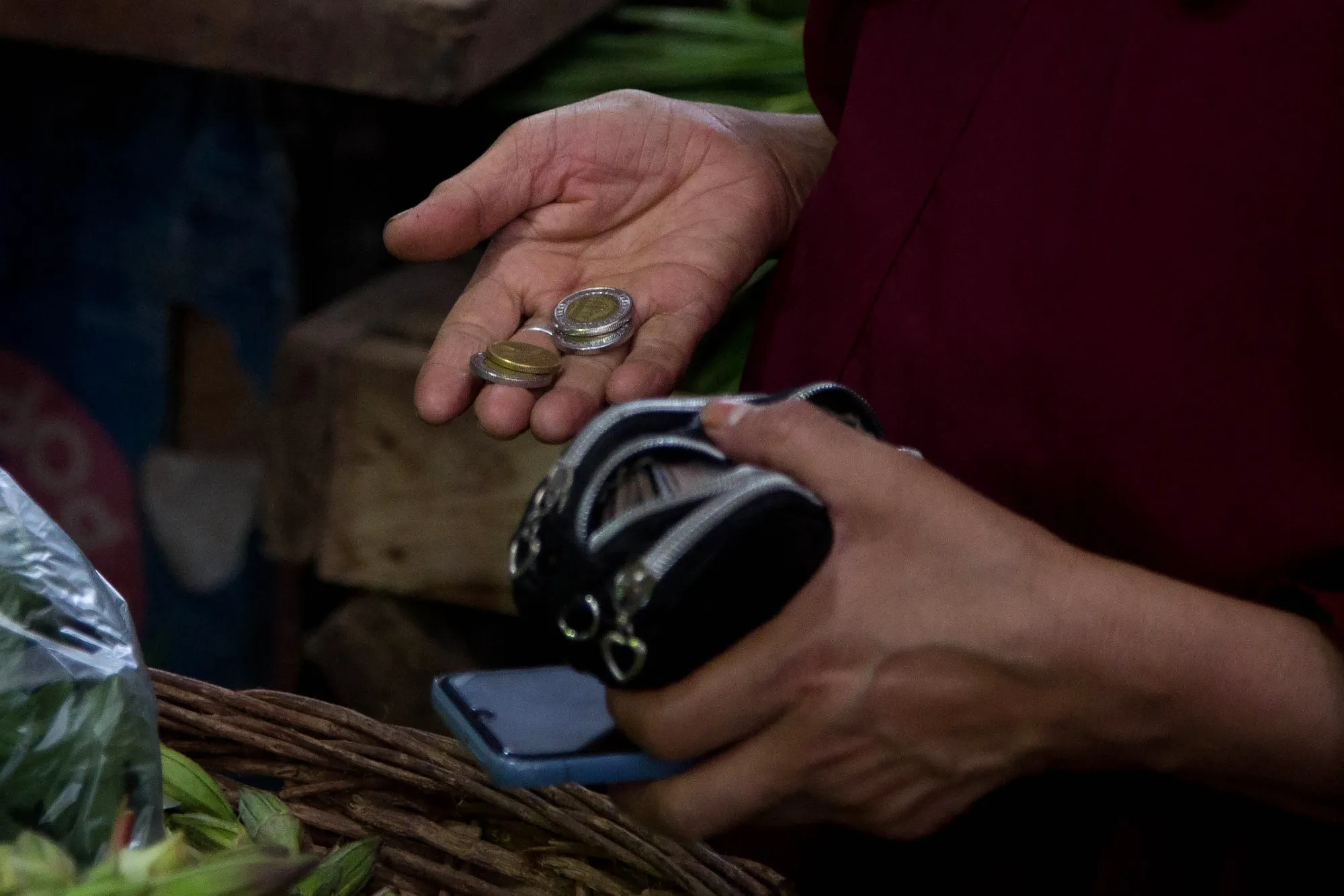 A customer selects Egyptian currency coins at a market in&nbsp;Cairo.