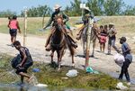 Border Patrol agents on horseback try to stop Haitian migrants from entering an encampment on the banks of the Rio Grande near the Acuna Del Rio International Bridge in Del Rio, Texas, on Sept. 19.