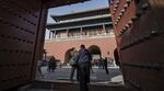 Visitors walk through a gate inside the Palace Museum at the Forbidden City in Beijing.