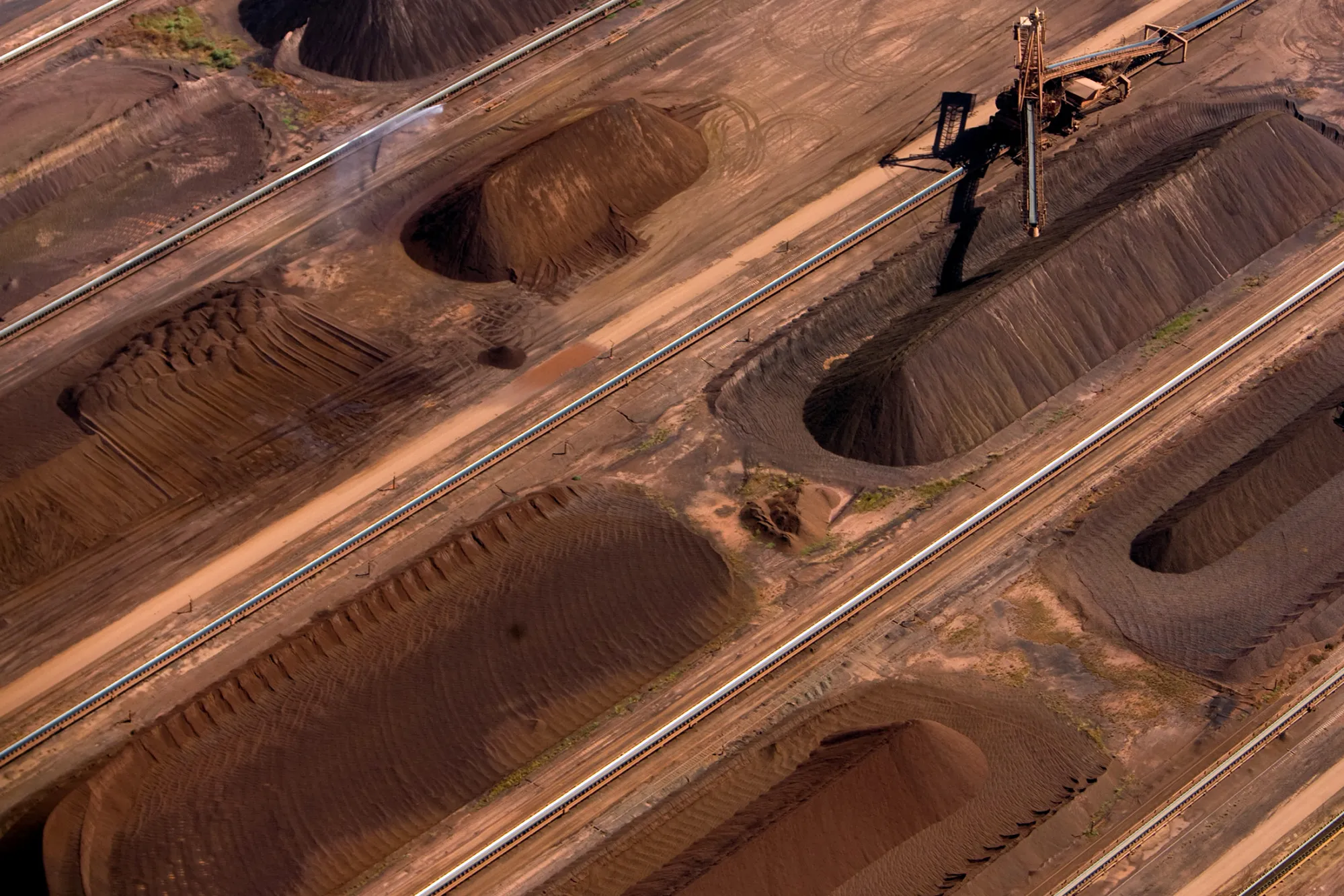 Iron ore awaits loading at BHP Billiton Ltd.'s loading facility at Nelson Point in&nbsp;Australia.