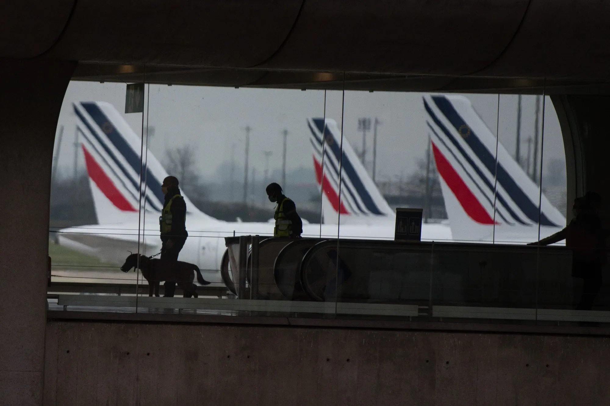 French police officers patrol a terminal building at Paris-Charles de Gaulle airport in Paris, France.