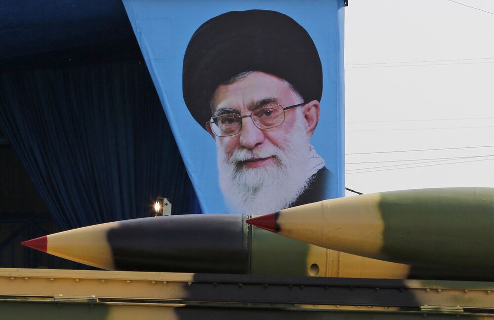 An Iranian military truck carries missiles past a portrait of Iran's Supreme Leader Ayatollah Ali Khamenei during a parade in Tehran.