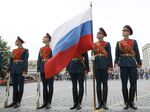 Russian soldiers hold the Russian national flag.&nbsp;