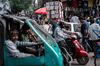 Pedestrians make their way through traffic in Chandni Chowk in the Old Delhi area of New Delhi, India.