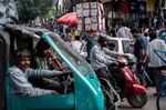 Pedestrians make their way through traffic in Chandni Chowk in the Old Delhi area of New Delhi, India.